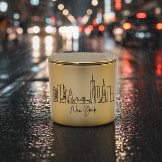 Candle with New York skyline design on a rainy city street