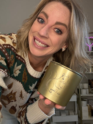 Joanna holding a gold squirrel candle
