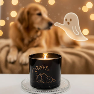 Boop candle on a clear coaster with a golden retriever in the background and a ghost booping him on the nose.