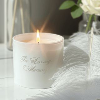 love square one white in loving memory candle ai generated on a window sil next to a white rose and a white feather