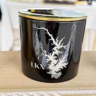 Black decorative item with white floral design and 'LKN' branding on a light wooden surface.