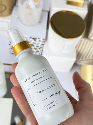 Hand holding a bottle labeled 'Moncello' with a blurred background