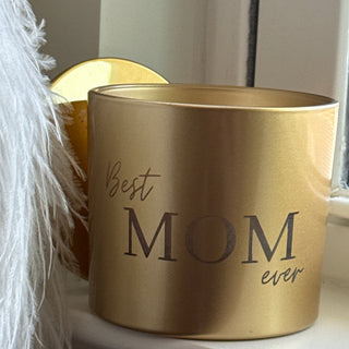 Gold cylindrical container with 'MOM ever best' text on a white surface.