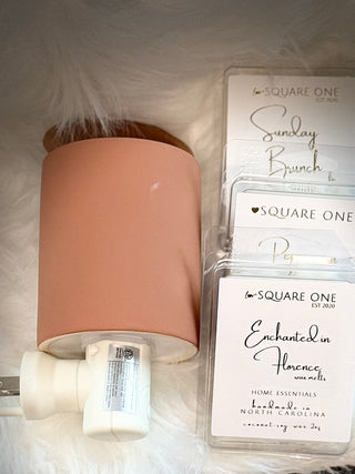 clay outlet wax warmer with   love Square One packaged wax melts  in the background.