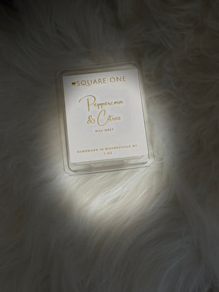 Square One peppercorn and citrus wax melt on a textured surface