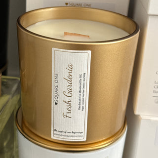 Gold candle holder with a label on a white background