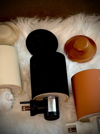 three different colored wax warmers outlet sized laying on white fur