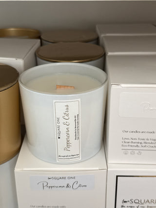 Candle with a label and boxes in the background