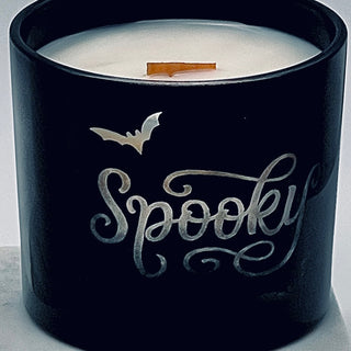 Black candle jar with 'Spooky' engraving on a gray background