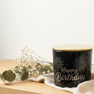 Happy birthday black candle on wood table