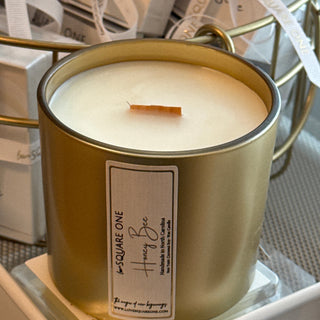 Gold Square One Honey Bee candle jar filled with creamy off white wax, a single wick, and a front label.