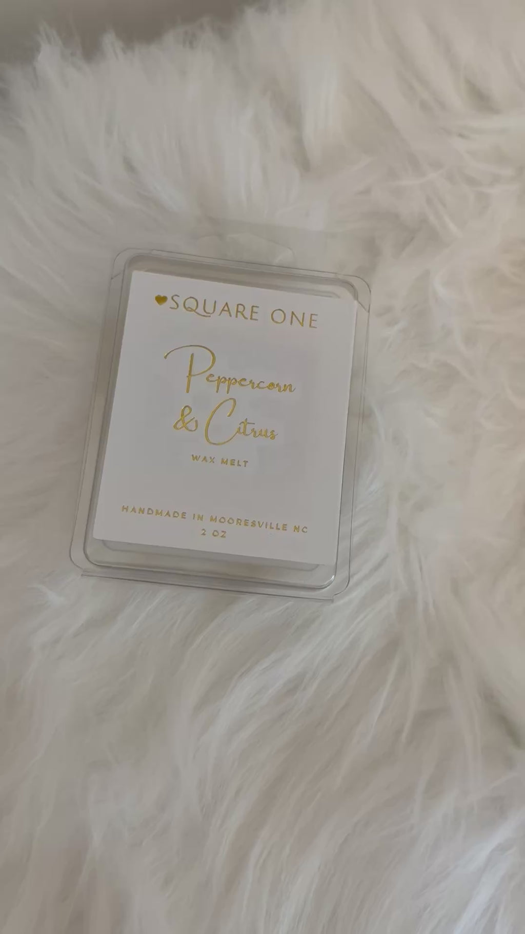 video of a peppercorn & citrus wax melt front and back packaging